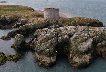 Tower on cliffs surrounded by the sea