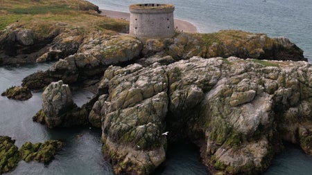 Tower on cliffs surrounded by the sea