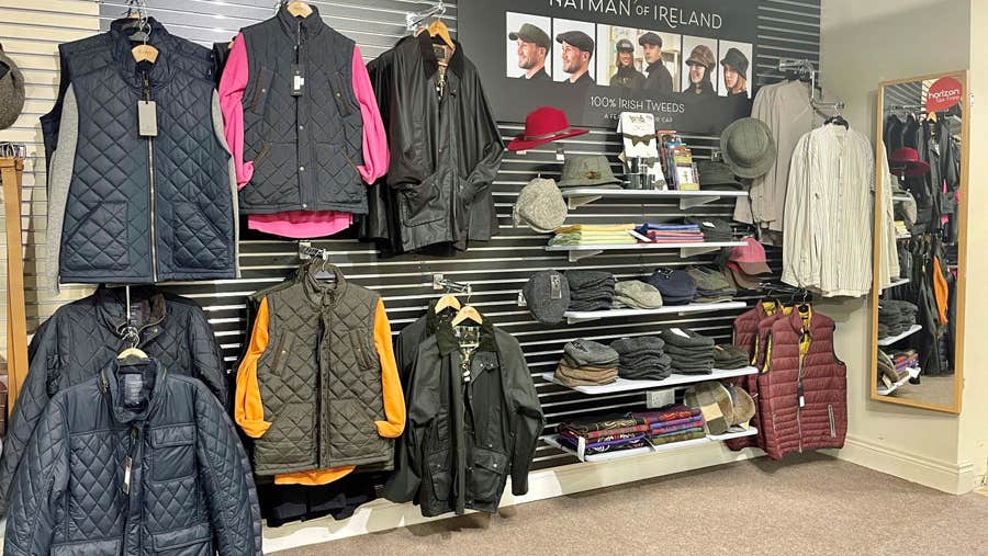 A display of coats jackets and hats in the gift shop of Connemara Gifts