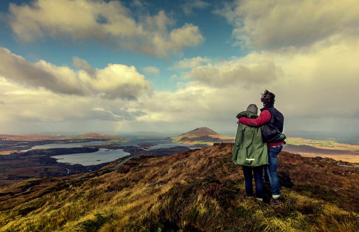 A couple on top of Diamond Hill overlooking Connemara National Park.