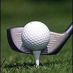 A club striking a golf ball