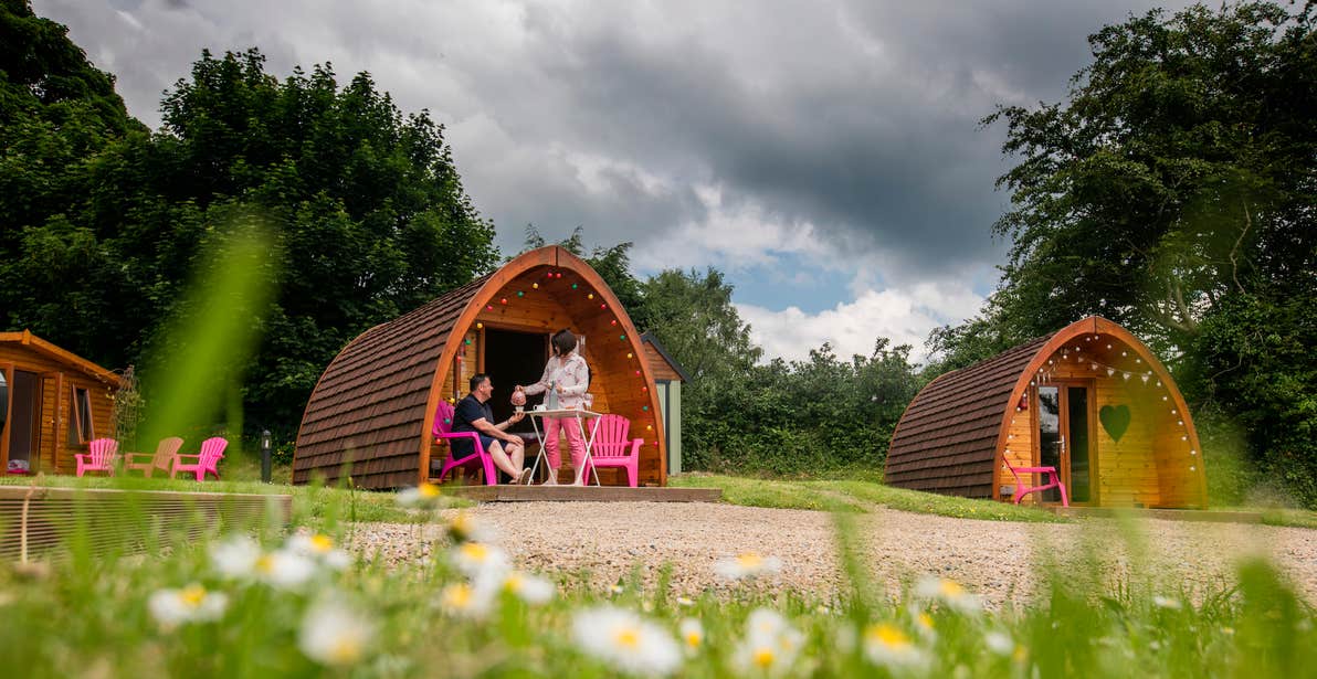 A couple outside a glamping pod at Pod Umna in County Galway