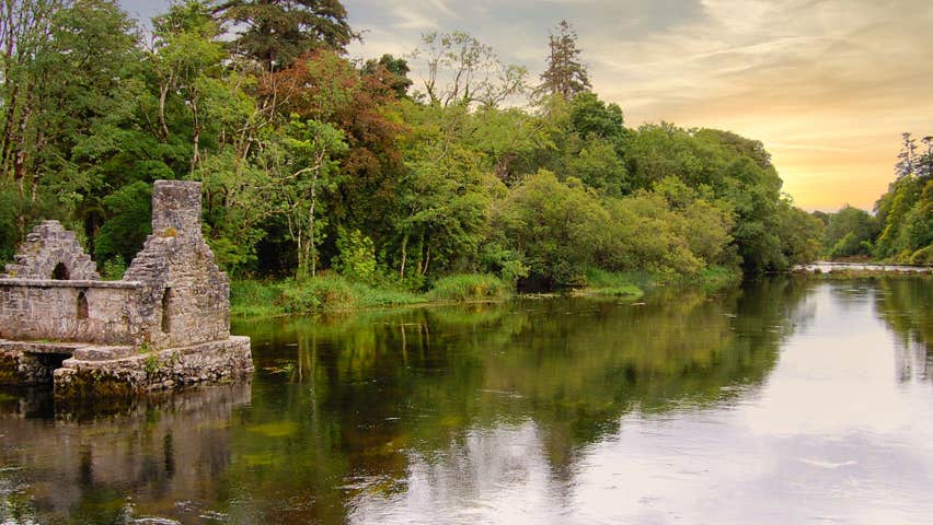 The ruins of a stone house beside a river