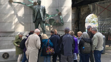 Group of people in front of a statue in Dublin City