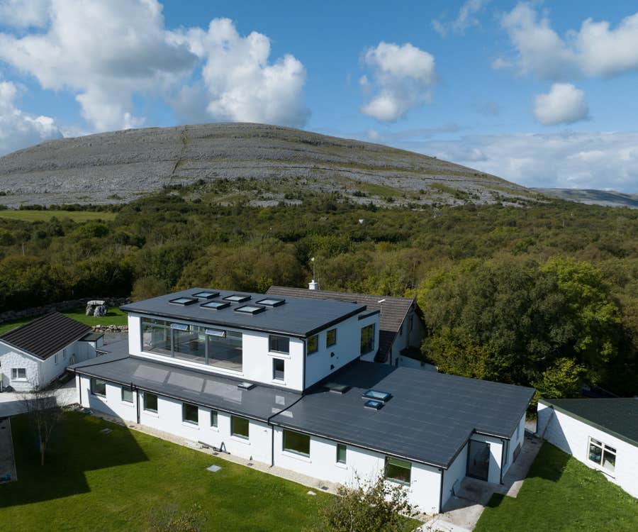Aerial shot of the Burren Yoga Retreat and Meditation Centre with the Burren landscape in the background