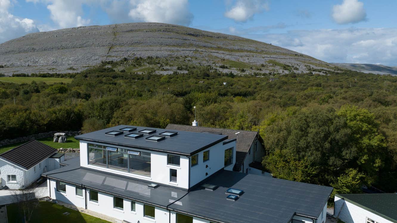 Aerial shot of the Burren Yoga Retreat and Meditation Centre with the Burren landscape in the background