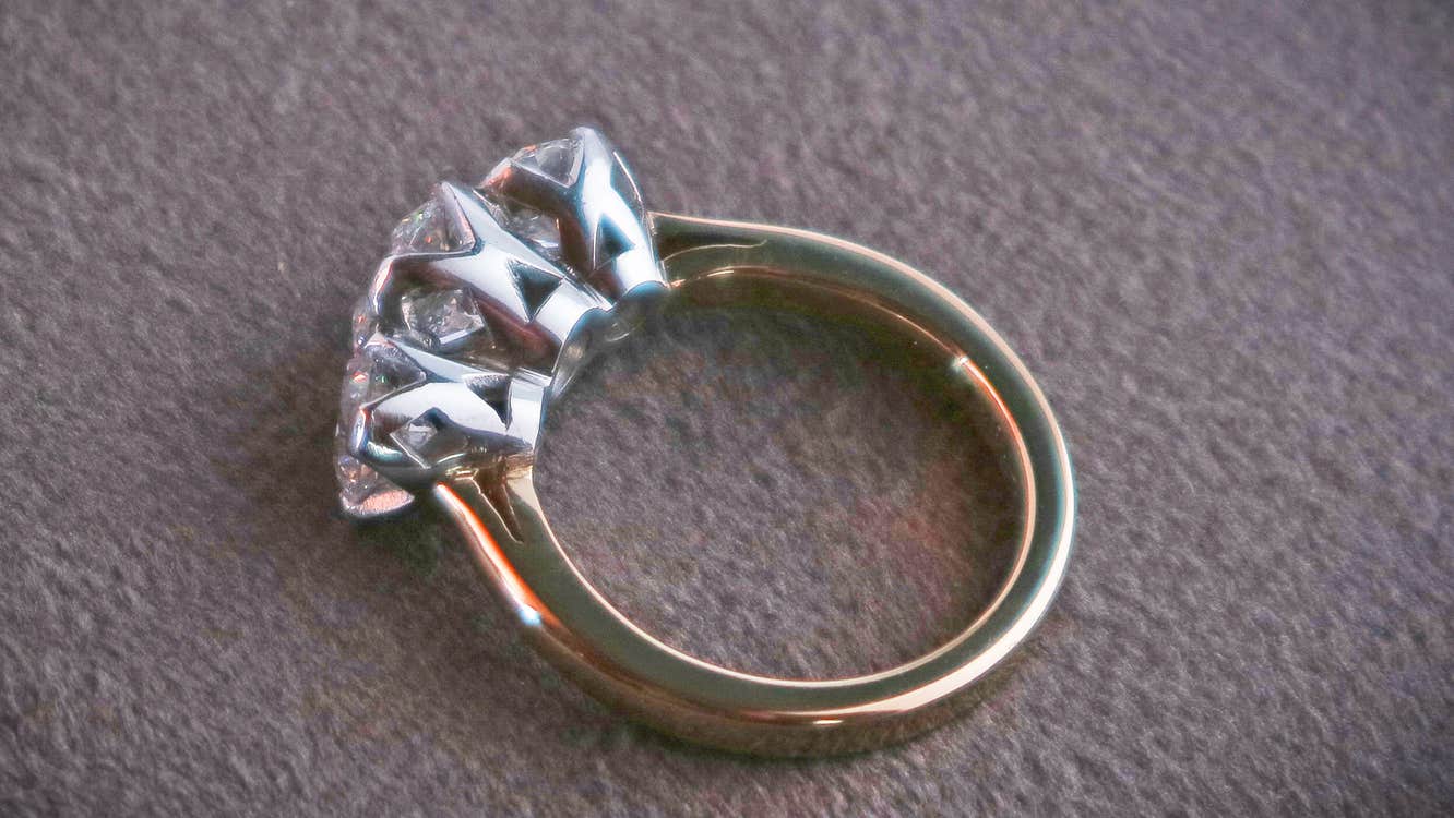 Tiffany Budd Goldsmith ring with gold band and three diamonds set in elegant silver mounts