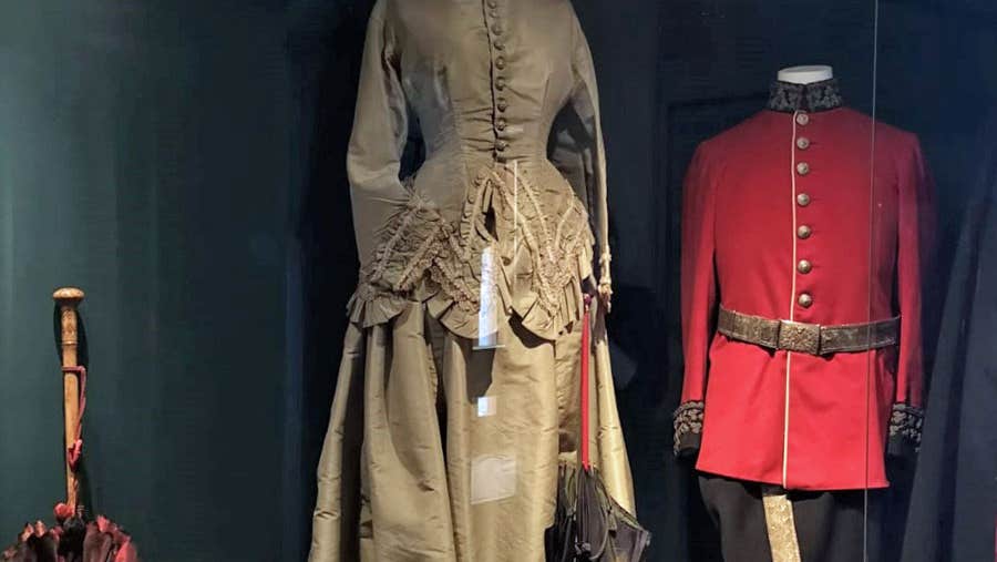 Image of lady's gold coloured costume and red military costume