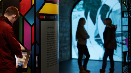 People looking at an interactive exhibit