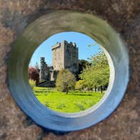 A view of a castle through a circular hole