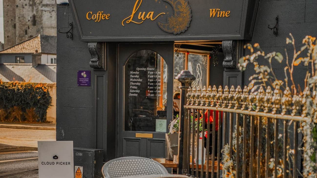 Café entrance with outdoor seating area overlooking Trim Castle
