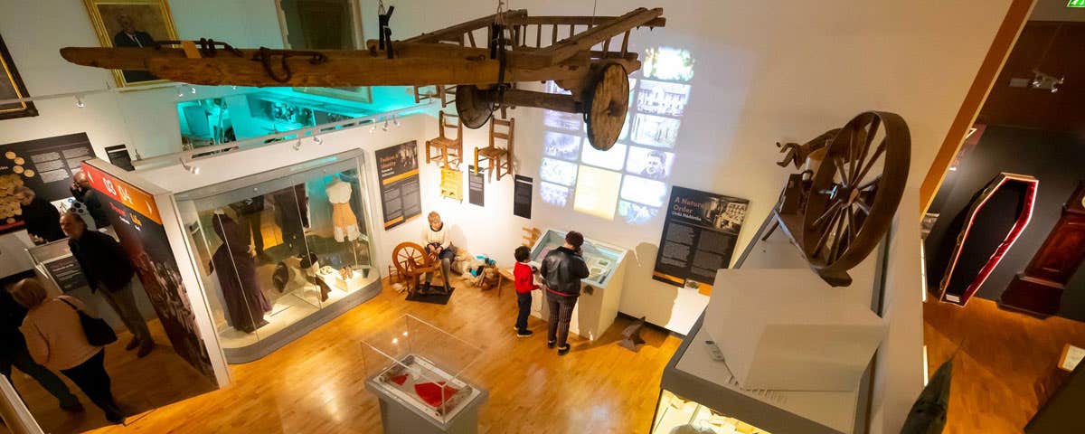 A view from the ceiling for the floor of the Tipperary Museum of Hidden History, with two people looking at a display