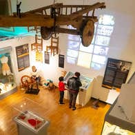 A view from the ceiling for the floor of the Tipperary Museum of Hidden History, with two people looking at a display