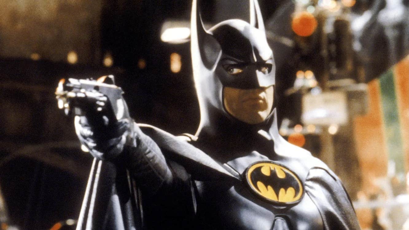 Batman pointing a firearm of some kind.