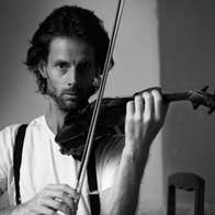 Black and white photo of serious looking man with beard playing a violin.