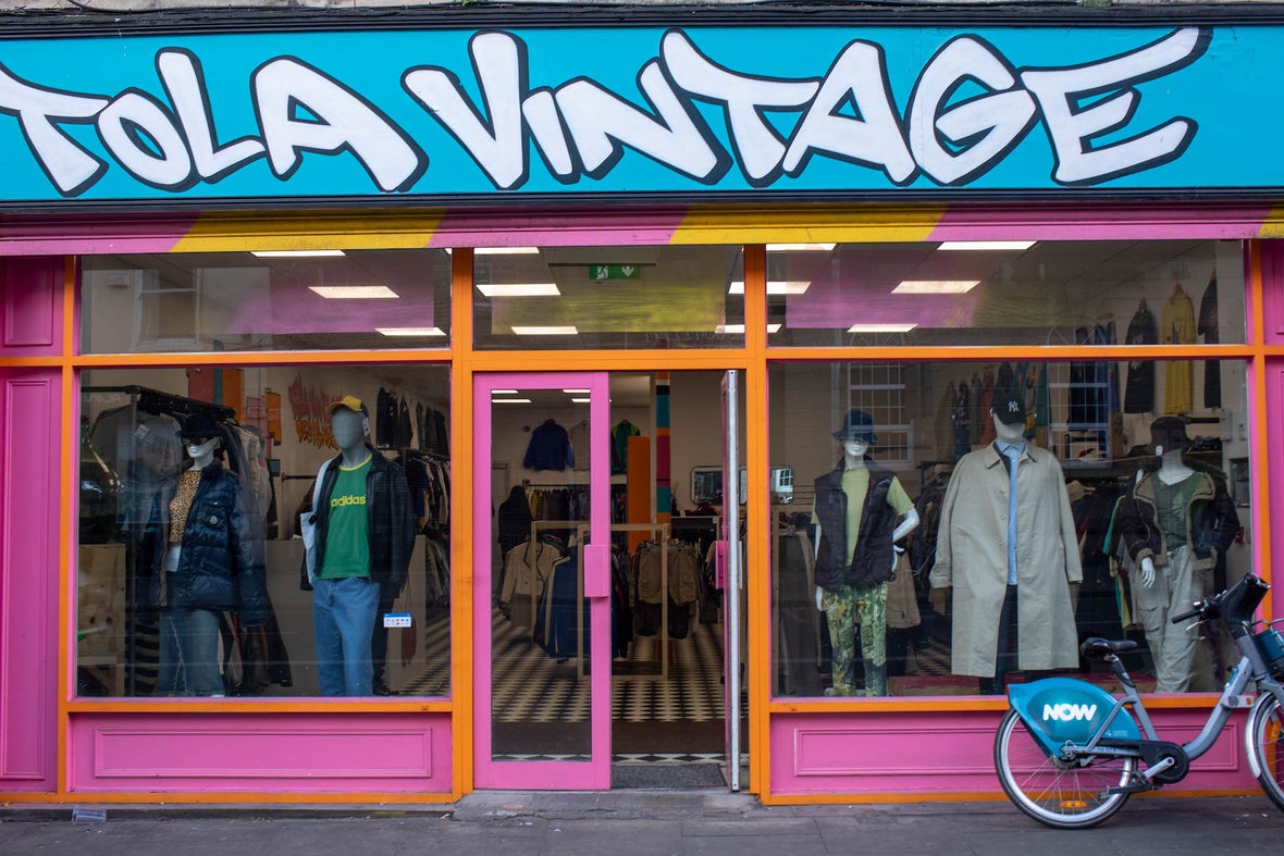 Colourful store front of Tola Vintage in Dublin. The store is painted in pink, orange and blue with the name painted in bold font.