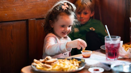 A girl eating chips and dip at Hogs & Heifers Bar & Grill Liffey Valley