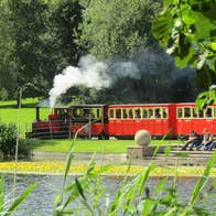 Train in motion through the gardens at Oakfield Park