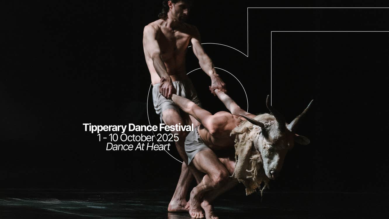 Performance of two dancers one performance wears the head mask of a ram the other dancer is pulling them back. Text says Tipperary Dance Festival the 1st to the 10th of October, dance at heart