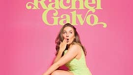 A woman in a short dress is squatting down with one hand raised up to her shocked face, against bright pink background.