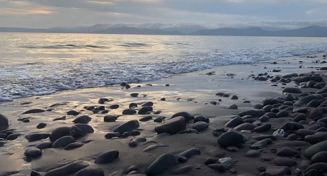 View out over Rossbeigh White Strand with the mountains in the background