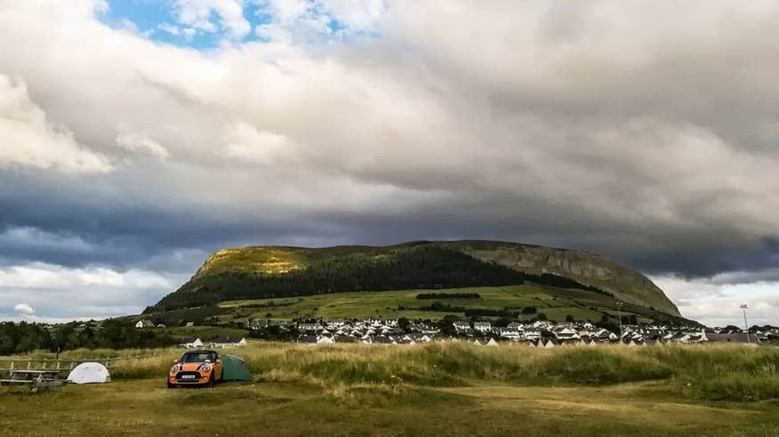 Tents and a car in from of a mountain at Strandhill Caravan and Camping Park, Strandhill, Sligo