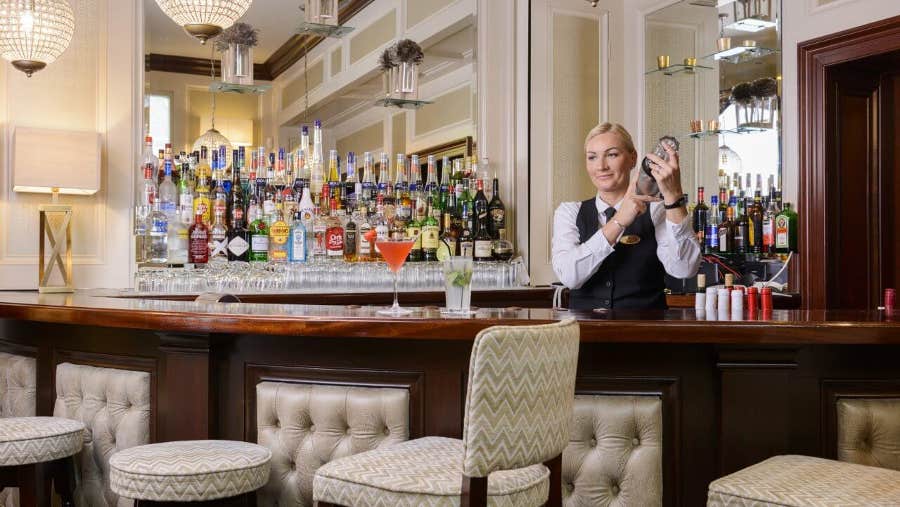 One of the bar staff tends the bar at Monks Lounge