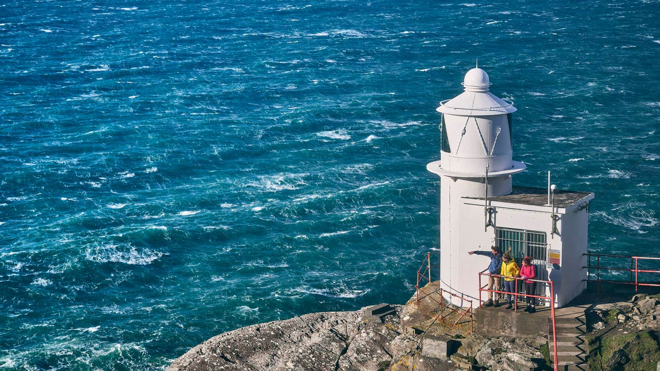 People looking out to sea from a lighthouse