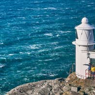 People looking out to sea from a lighthouse