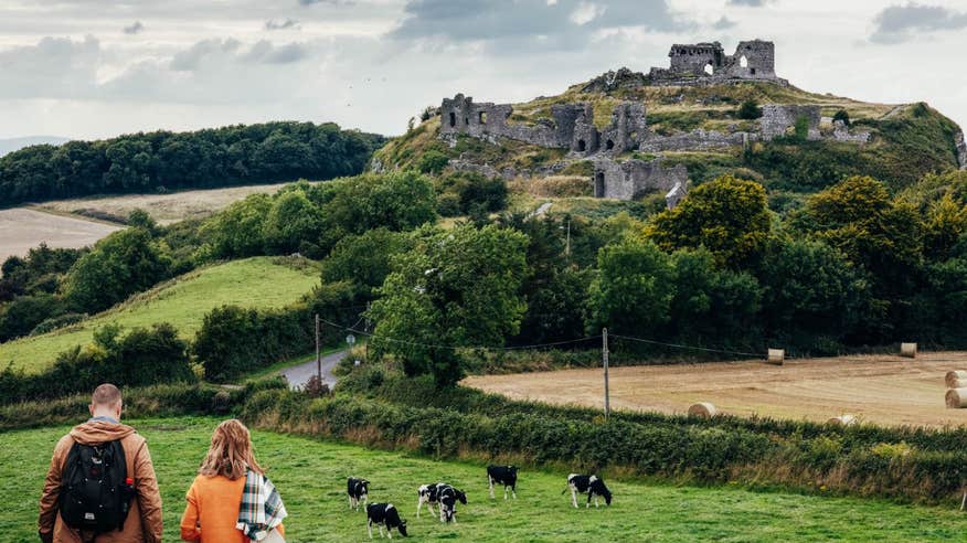 A couple walking towards the ruins at the Rock of Dunamase, Laois