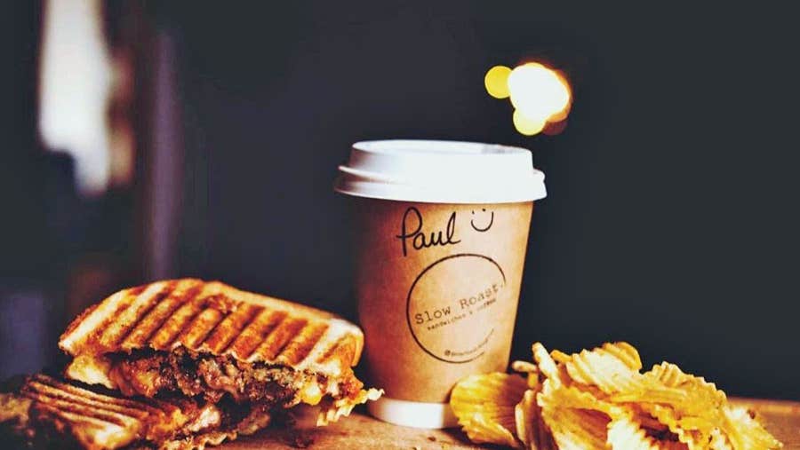 Close up image of a toasted sandwich coffee and crisps