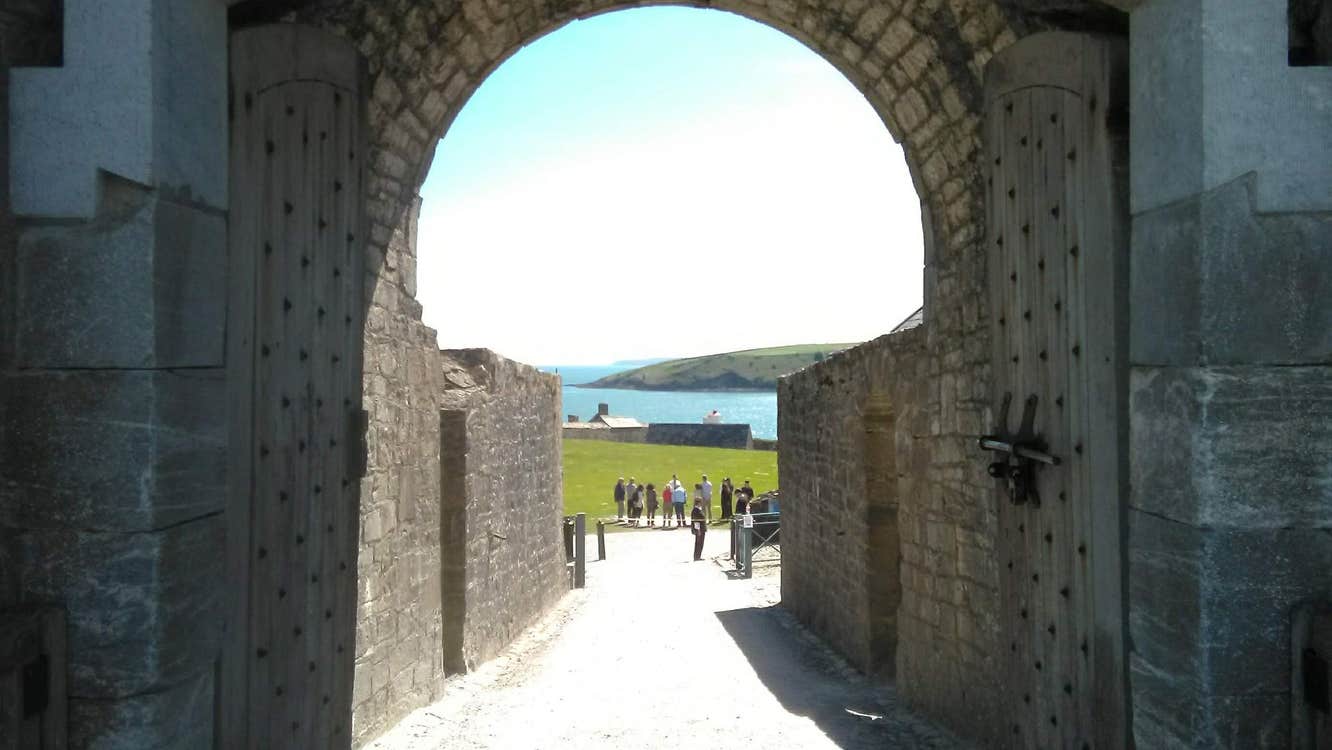 Cork West Transfers and Tours view of a tour group through a stone archway