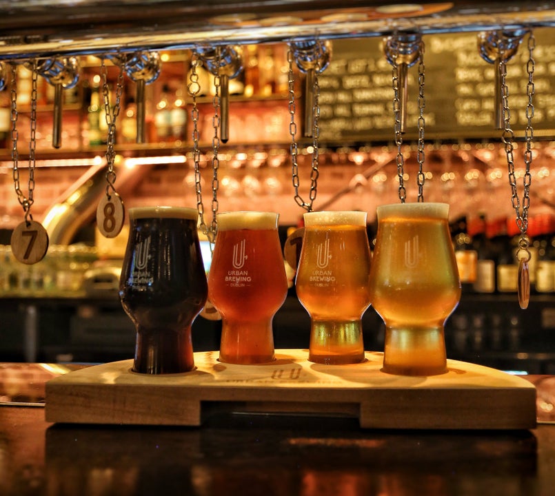 A bar counter with four glasses of beer