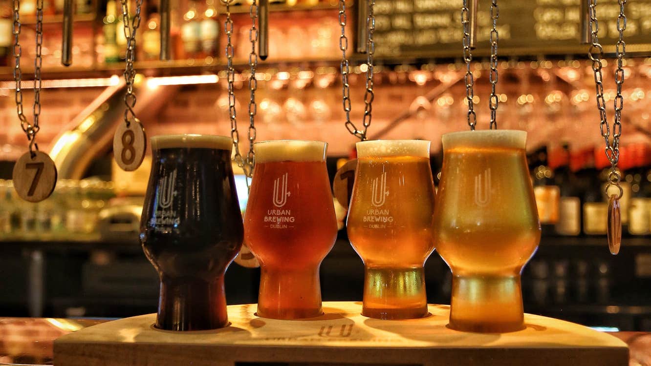 A bar counter with four glasses of beer