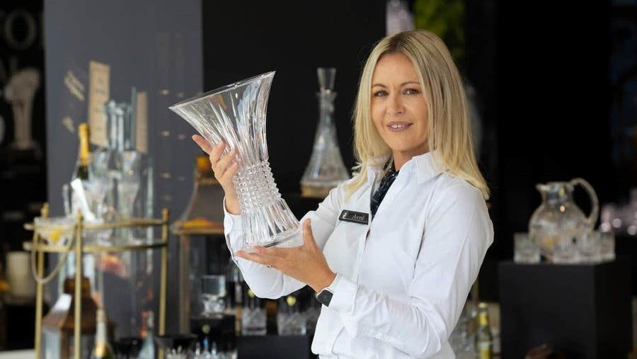 Avril holds a crystal vase in the House of Waterford Crystal retail store