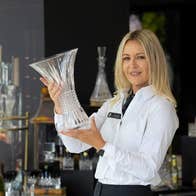 Avril holds a crystal vase in the House of Waterford Crystal retail store