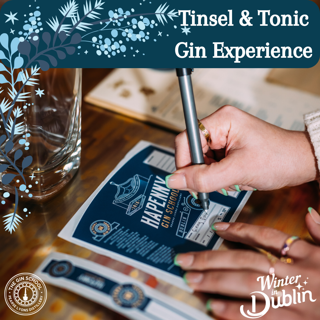 Create your own Christmas Gin. Hands are holding a gin label and pen, writing on the label.