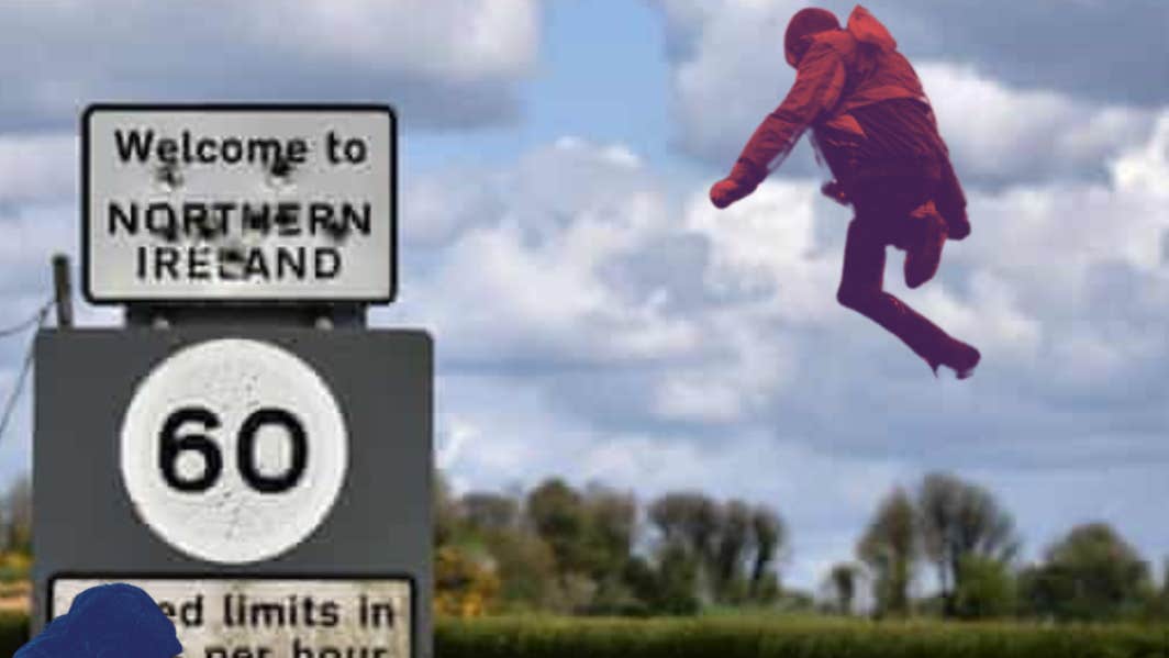 Beyond The Border – MAD Youth Theatre, A person dressed in dark red leaping up in the sky beside a road sign