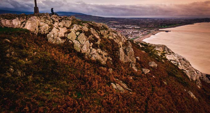 Cross on a hill looking out to sea with Bray in the background