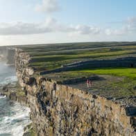 View of steep cliffs above the water at the Aran Islands