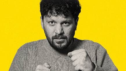 Killian Sunderland, Killian Dollar Baby - a man in knitted jumper holding his hands up in 2 fists.