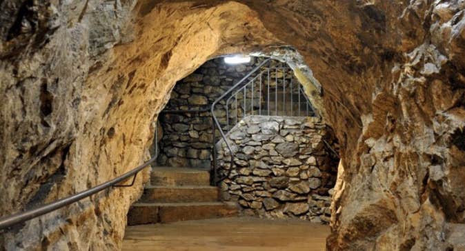 Inside the Glengowla Mine with steps in the distance and a hand rail in the foreground