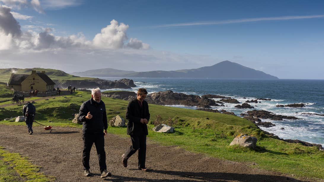 Director Martin Mc Donagh and actor Colin Farrell, are pictured walking on set of the 'The Banshees of Inisherin', with the peaks of Slievemore in the background.