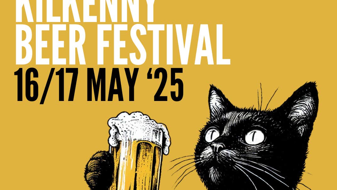 A black cat holding up a large glass of yellow beer, against dull yellow background with white or black text.