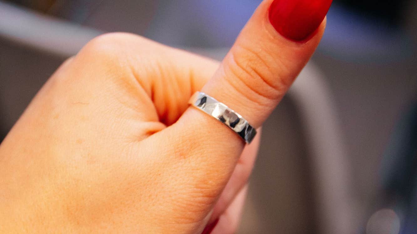 Silver ring on red nail varnished thumb at Silverworks