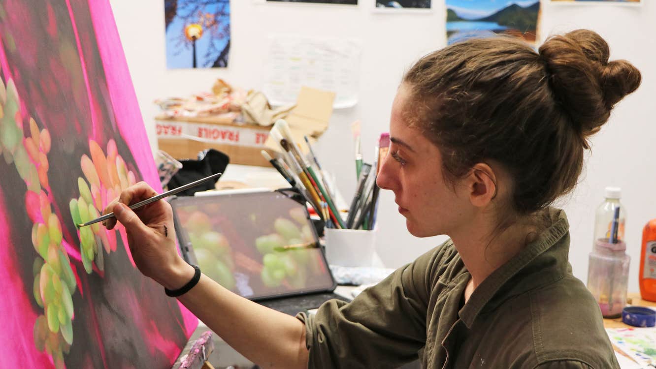 Burren College of Art showing an artist painting a colourful canvas