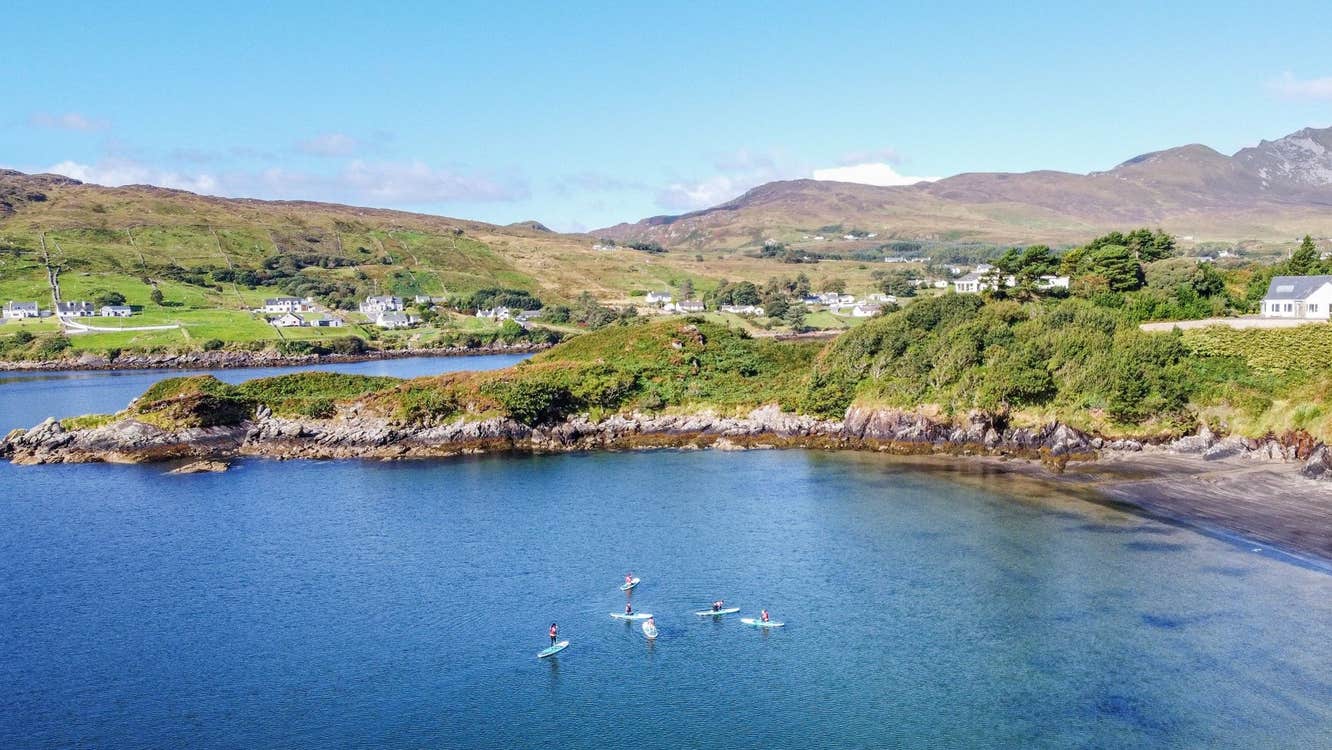 Aerial view of a group of stand up paddle boarders in a small harbour
