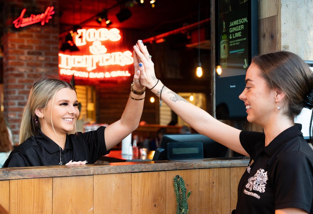 Staff high fiving at Hogs & Heifers Bar & Grill Liffey Valley