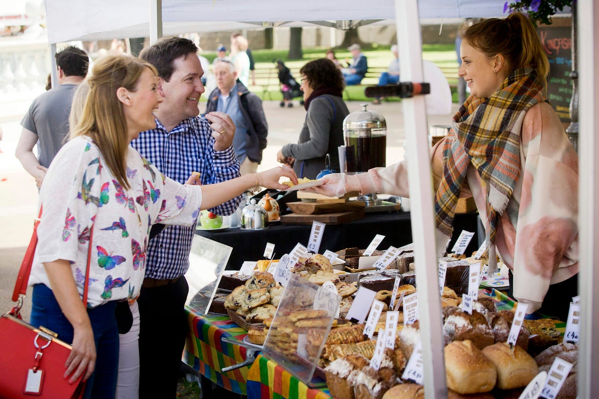 Image of people tasting food at a stall in the People's Park Market in Dun Laoghaire.
