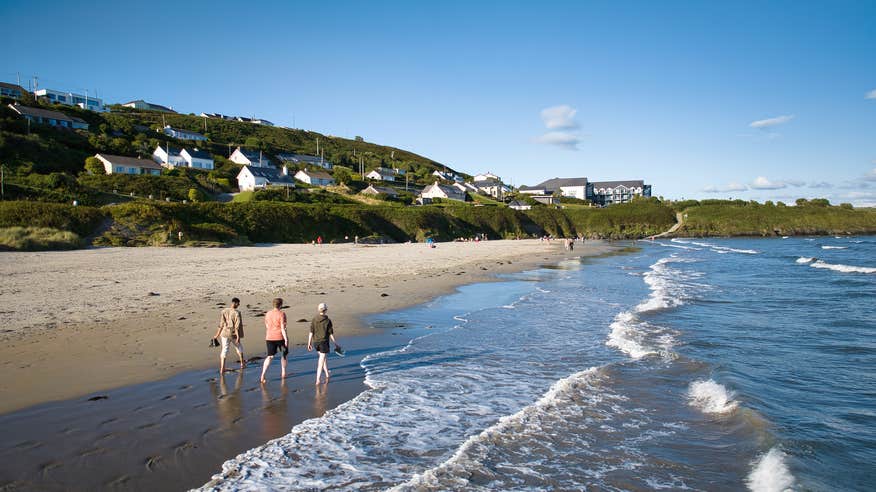 Aerial view of people walking on Incydoney Beach in County Cork